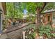 Backyard with outdoor seating and dining on stone patio with privacy fence and garden at 2253 N Williams St, Denver, CO 80205