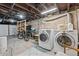 Basement with washer and dryer, exposed beams, and concrete floor at 2253 N Williams St, Denver, CO 80205