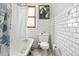 Charming bathroom featuring a classic clawfoot tub, tiled walls, and natural light at 2253 N Williams St, Denver, CO 80205