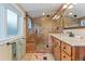 Well-lit bathroom featuring a modern tile shower with glass door and a wood vanity at 2253 N Williams St, Denver, CO 80205