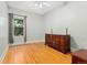 Bright bedroom features hardwood floors, a large window, and an antique dresser at 2253 N Williams St, Denver, CO 80205