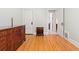 Bedroom featuring hardwood floors with a door that leads to a bathroom with white tiled floors at 2253 N Williams St, Denver, CO 80205