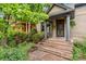 Inviting front porch with brick steps, columns, a secure door, and well-maintained landscaping at 2253 N Williams St, Denver, CO 80205