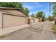 View of detached garages with alley access and concrete driveways at 2253 N Williams St, Denver, CO 80205