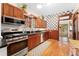 Well-lit kitchen offering stainless steel appliances, dark countertops, and access to backyard at 2253 N Williams St, Denver, CO 80205