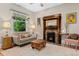 Bright living room features hardwood floors, vintage fireplace, a large window, and stylish decor at 2253 N Williams St, Denver, CO 80205