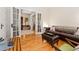 Comfortable living room featuring hardwood floors, french doors, and a beautiful leather sofa at 2253 N Williams St, Denver, CO 80205