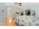 Main bedroom offers a ceiling fan, hardwood floors, and a view of the ensuite bathroom at 2253 N Williams St, Denver, CO 80205