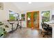 A sun room with tile floors, windows and French doors that lead to a garden at 2253 N Williams St, Denver, CO 80205