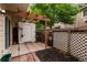 A backyard patio with a white shed, small garden area, and privacy fence at 8126 Gray Ct # 499, Arvada, CO 80003