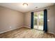 A bedroom featuring wood-look flooring and a sliding glass door leading to an outdoor patio at 8126 Gray Ct # 499, Arvada, CO 80003