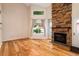 Sunlit living room featuring a stone fireplace, large windows, and hardwood floors at 8126 Gray Ct # 499, Arvada, CO 80003