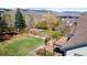 Expansive backyard featuring a lush lawn, a play structure, a deck, and mountain views at 16652 W Archer Ave, Golden, CO 80401