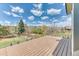 View of a backyard featuring mature trees, playset, grass, and mountains in the distance at 16652 W Archer Ave, Golden, CO 80401