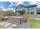 A spacious backyard with a modern deck, stone pathway, and lush greenery at 16652 W Archer Ave, Golden, CO 80401