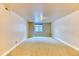 Unfurnished basement bedroom with tan walls, carpet and a window for natural light at 16652 W Archer Ave, Golden, CO 80401
