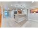 Basement wet bar features a tile floor, bar-top seating, sink and ample shelving space at 16652 W Archer Ave, Golden, CO 80401