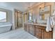 Luxurious bathroom with a soaking tub, walk-in shower, dual vanity, and modern fixtures at 16652 W Archer Ave, Golden, CO 80401
