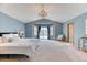 Bright Primary bedroom with a chandelier, bay window, and neutral color palette at 16652 W Archer Ave, Golden, CO 80401