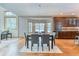 Dining room with hardwood floors, table with six chairs, and an adjacent modern kitchen at 16652 W Archer Ave, Golden, CO 80401