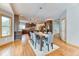 Open-concept dining area with wood floors and stylish light fixture adjacent to the kitchen at 16652 W Archer Ave, Golden, CO 80401