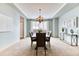 Elegant dining room featuring a modern chandelier, ample seating, and neutral decor at 16652 W Archer Ave, Golden, CO 80401