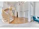Spacious foyer with a curved staircase, hardwood floors, and a grand chandelier at 16652 W Archer Ave, Golden, CO 80401