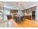 Bright kitchen with hardwood flooring, an island with seating, and stainless steel appliances at 16652 W Archer Ave, Golden, CO 80401