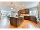 Open kitchen design with a center island, hardwood floors, and modern appliances at 16652 W Archer Ave, Golden, CO 80401
