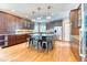 Spacious kitchen boasts wood floors, a large island with seating, and stainless steel appliances at 16652 W Archer Ave, Golden, CO 80401