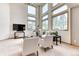 Bright, open living room with tall ceilings, a modern sofa, and large picture windows at 16652 W Archer Ave, Golden, CO 80401