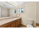 Bathroom with a single sink vanity, large mirror and tile floor at 1175 Xanthia, Denver, CO 80220