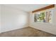 Bright bedroom featuring a large window providing natural light and neutral carpet, ready for personalization at 1175 Xanthia, Denver, CO 80220