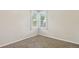 Small bedroom with a corner window and neutral carpet at 1175 Xanthia, Denver, CO 80220
