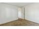 This cozy bedroom features neutral carpeting, white walls, and an open doorway, creating a bright, airy feel at 1175 Xanthia, Denver, CO 80220
