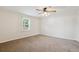 Simple bedroom with a bright window and neutral colored carpet at 1175 Xanthia, Denver, CO 80220