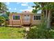 Charming single-story home with a cozy front deck, double doors, and well-maintained lawn at 1175 Xanthia, Denver, CO 80220