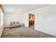 Cozy living room featuring neutral carpet, white walls, and a glimpse into the kitchen at 1175 Xanthia, Denver, CO 80220