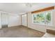 Bright living room with large window and double doors providing ample natural light at 1175 Xanthia, Denver, CO 80220
