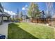 Expansive backyard featuring lush green grass and a wooden fence for privacy at 7961 E 131St Ave, Thornton, CO 80602