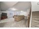 Spacious basement with plush carpet, a large sectional sofa and a staircase at 7961 E 131St Ave, Thornton, CO 80602