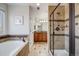 This bathroom features a soaking tub, tiled shower and vanity with sink at 7961 E 131St Ave, Thornton, CO 80602