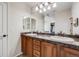 This bathroom features a double vanity with storage and large mirror at 7961 E 131St Ave, Thornton, CO 80602