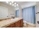 This bathroom features a vanity with sink and shower-tub combination at 7961 E 131St Ave, Thornton, CO 80602