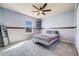 This bedroom features a soft blue color scheme and carpeting at 7961 E 131St Ave, Thornton, CO 80602