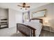 Bright bedroom features a wooden bed frame, closet, and a large mirror at 7961 E 131St Ave, Thornton, CO 80602