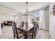 Elegant dining room with a large table, stylish lighting, and a seamless flow to the living area at 7961 E 131St Ave, Thornton, CO 80602