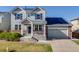 Charming two-story home with a brick-accented facade, gray siding, and a well-manicured lawn at 7961 E 131St Ave, Thornton, CO 80602
