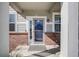 Inviting front porch showcasing brick accents, a neutral door, and charming decorative details at 7961 E 131St Ave, Thornton, CO 80602