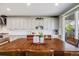 Spacious kitchen with white cabinets, stainless steel appliances, and a large dining table near a sliding glass door at 7961 E 131St Ave, Thornton, CO 80602